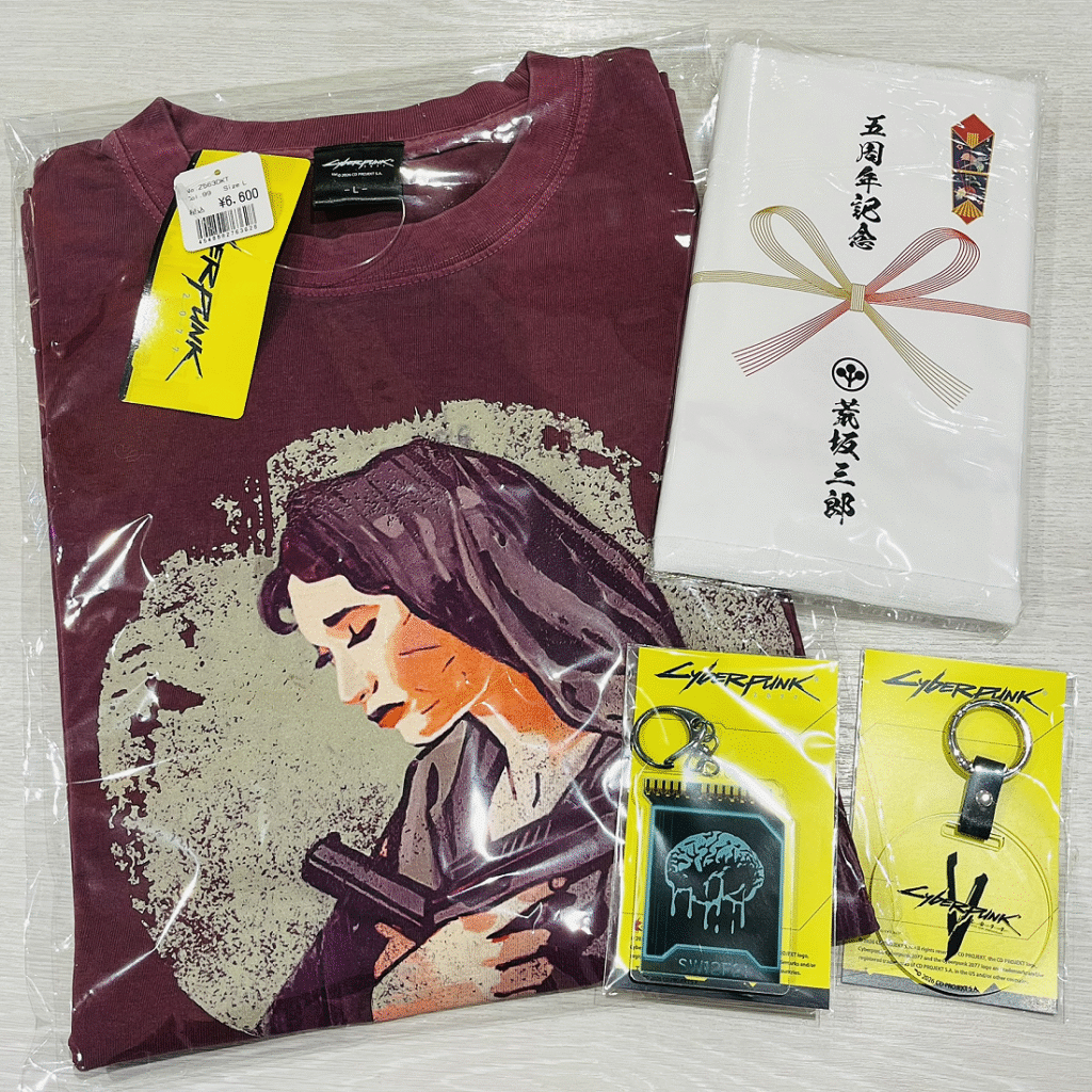 JAPAN POP UP SHOP merch items I bought: Jackie tank top design T-shirt, Quickhack Synapse Burnout key chain, 5th anniversary key chain, purchase benefit towel from Saburo Arasaka lol (White towel with paper that Saburo Arasaka name in kanji on it).